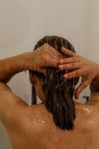 Kaboompics - Woman Massaging Wet Hair Under Shower Water
