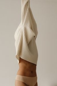 Kaboompics - Ribbed Cream Knit Sweater Detail in a Minimal Neutral Fashion Portrait