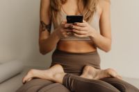 Kaboompics - Woman Using a Smartphone While Sitting Cross-Legged