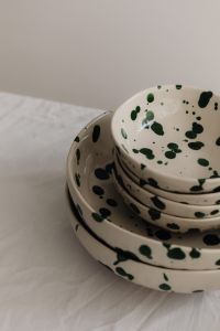 Kaboompics - Green Splatter Bowl Stack against a Neutral Background