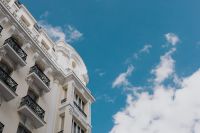 Kaboompics - Low-Angle Madrid Apartment Facade with Black Iron Balconies and Blue Sky