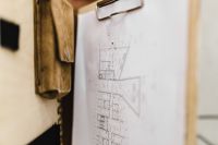 Kaboompics - Close-Up Architectural Floor Plan Clipped to a Tan Leather Portfolio
