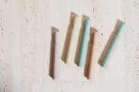 Kaboompics - Pastel Chalk Sticks in Blush, Mint and Cream on Stone for Minimal Classroom Styling