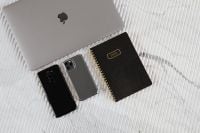 Kaboompics - Minimal Tech Still Life of Two Smartphones, Laptop and Dated Planner