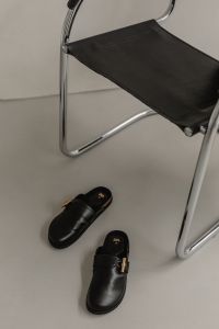 Kaboompics - Black Leather Mules Beneath Chrome Chair