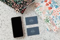 Kaboompics - Blue Business Card Mockup with Smartphone and Colorful Stationery on Terrazzo