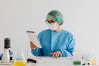 Kaboompics - Lab Technician Reading Research Notes