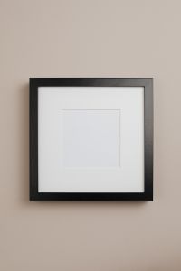 Kaboompics - Centered Black Picture Frame on Beige Wall, Minimalist Empty Frame Mockup