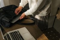 Kaboompics - Packing Tablet Into Black Leather Work Bag