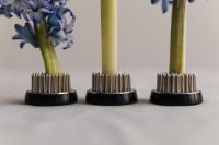 Kaboompics - Three Kenzan Flower Frogs Aligned on a Linen Surface