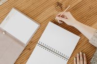 Kaboompics - Open Notebooks and Gold Pen on Wooden Desk