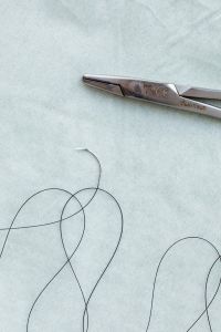 Kaboompics - Surgical Needle Holder and Suture Thread With Copy Space