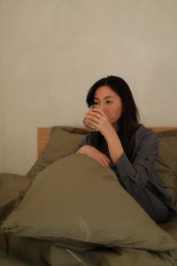 Kaboompics - Relaxing in Bed by the Window with a Warm Drink