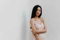 Kaboompics - Minimalist Editorial Portrait of Woman in Pale Dress against White Wall