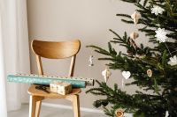 Kaboompics - Gift Wrapping Station with Christmas Tree and Chair