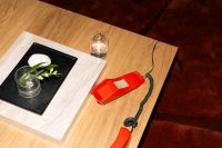 Kaboompics - Retro Red Telephone On Wooden Coffee Table With Decor
