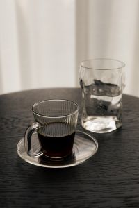 Kaboompics - Black Coffee and Water Glass on Black Round Table