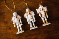 Kaboompics - Three Nutcracker Decorations on Rustic Wood