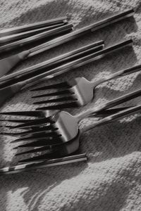 Kaboompics - Close-Up Matte Steel Forks Overlapping on Textured Fabric