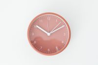 Kaboompics - Close-Up of a Rose-Pink Clock Face with White Numerals and Hands on a Pale Background