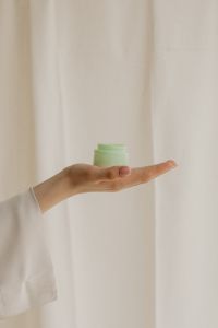 Kaboompics - Open Jar of Moisturizing Cream Displayed on an Open Hand