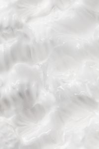 Kaboompics - Glossy White Skincare Cream Mounds with Soft Curved Highlights, Abstract Macro