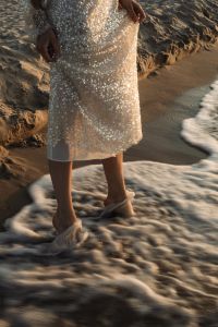 Kaboompics - Barefoot Woman Standing in Sea Foam by Coastal Dunes