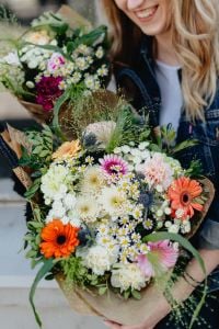 Kaboompics - Close-Up Portrait with Mixed Flower Basket and Denim Jacket