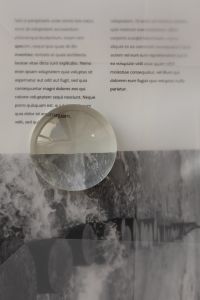 Kaboompics - Glass Paperweight on Editorial Page and Black and White Photo