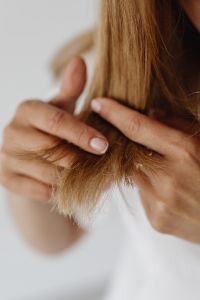 Kaboompics - Woman Inspecting Split Ends in a Hair Care Close-Up
