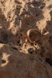 Kaboompics - Close-Up Gold Band on Porous Coastal Stone