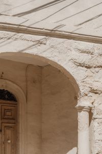 Kaboompics - White Limestone Archway with Carved Column and Weathered Facade