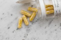 Kaboompics - Bead-Filled Capsules Beside an Open Supplement Bottle