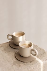 Kaboompics - Two Ceramic Latte Mugs on Coasters and a Textured Stone Block