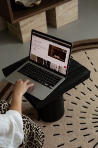 Kaboompics - Woman Using Laptop on Black Side Table at Home