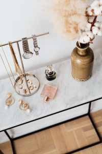 Kaboompics - Vertical Marble Vanity Scene with Jewelry Stand, Watch, Perfume and Dried Flower Vase