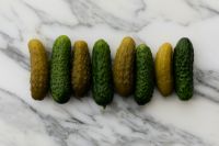 Kaboompics - Fresh Cucumbers and Pickles Arranged on White Marble Background