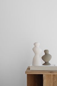 Kaboompics - Close-Up of Sculptural Ceramic Vases on a Book and Oak Side Table