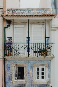Kaboompics - Lisbon Azulejo Facade with Wrought-Iron Balcony, Shuttered Windows and Blue Tiles