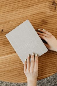 Kaboompics - Hand Resting on Closed Bullet Journal
