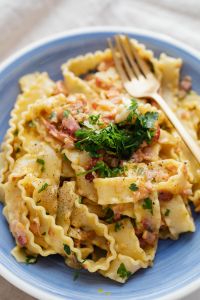 Kaboompics - Fork Resting on Bacon Carbonara in a Blue Bowl, Top View