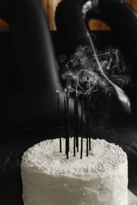 Kaboompics - White Cake with Smoking Black Candles