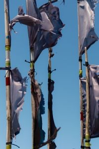 Kaboompics - Weathered Harbor Flags Against Blue Sky