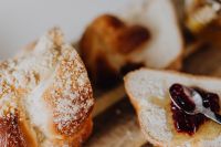 Kaboompics - Sliced Challah With Jam and Knife on Wooden Board