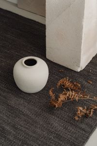 Kaboompics - White Textured Ceramic Vase with Green Leaves and Copy Space