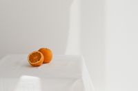 Kaboompics - Whole and Sliced Oranges on White Linen with Copy Space, Minimal Summer Citrus Still Life