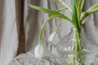 Kaboompics - White Tulip Bouquet in Textured Glass Vase on Neutral Linen, Soft Spring Still Life