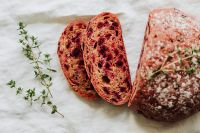 Kaboompics - Cut Beetroot Bread Beside Whole Loaf and Thyme