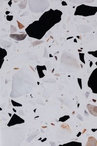 Kaboompics - White Terrazzo Texture with Oversized Black Stone Pieces and Pale Gray Chips