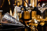 Kaboompics - Close-Up Silver Party Horn with Gold Cone Hat and Champagne Bokeh